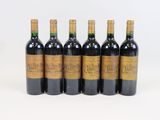 six bottles of red wine are lined up in a row