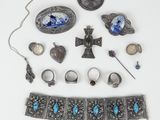 an assortment of silver and turquoise jewelry on a white surface