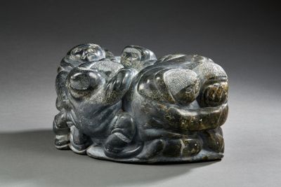 a statue of a man and a woman laying on the ground
