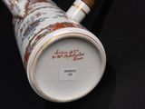 a close up of a vase on a black surface