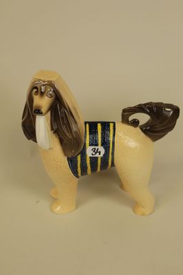 figurine of a dog with a baseball glove on it ' s head