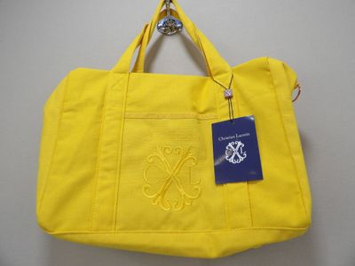a yellow tote bag with a blue tag on it