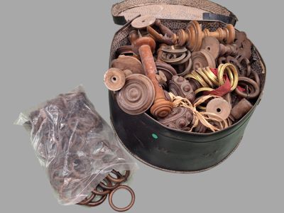a metal container filled with assorted items on a gray surface