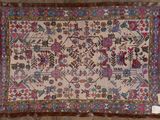 an antique rug with a floral design on a white background