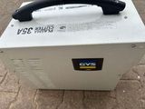 a white box with a black handle sitting on the ground