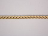 a close up of a gold chain on a white surface