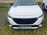 a white car that is parked in the grass