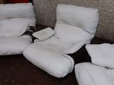 three white recliners sitting on the floor in a room