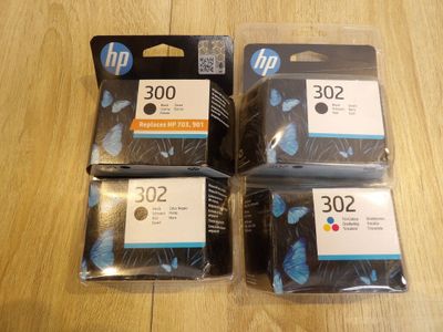 trois cartouches d'encre HP 302 sont empilées les unes sur les autres