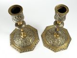 pair of antique brass candlesticks on a white background