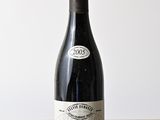 a bottle of wine sitting on a wooden table