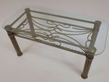 a glass table with a metal frame and a glass top