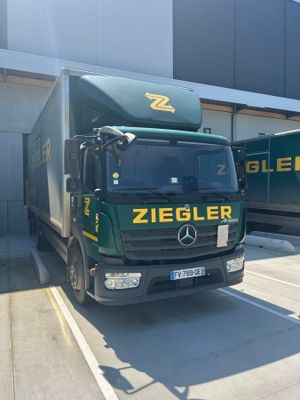 two trucks that are parked in front of a building