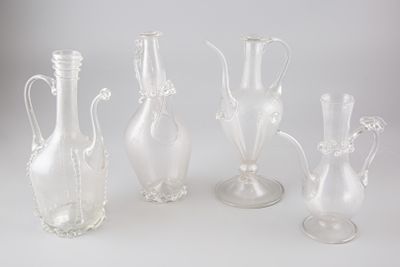 cinq vases en verre posés les uns à côté des autres sur une table