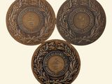 three bronze coins with a crown and laurels on them