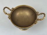 an antique brass cup with handles and handles on a white surface