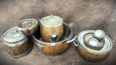 several pots and pans are lined up on a brown surface