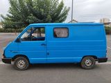 a blue van that is parked in a parking lot