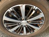 the tire of a car is shown on the gravel road