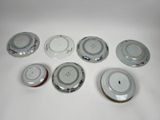 several plates with different designs are arranged on a white surface