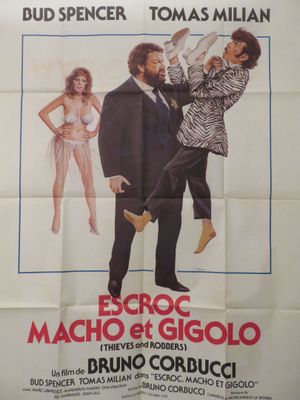 une vieille affiche de cinéma représentant un homme et une femme en smoking