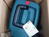 a blue vacuum in a cardboard box with a price tag on it