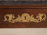 a gold decoration on the top of a wooden desk