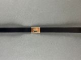 a close up of a black belt with a gold buckle on it