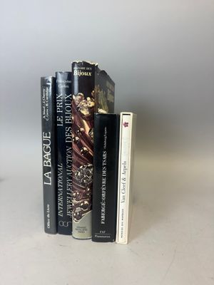 trois livres posés sur une table blanche