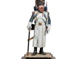 figurine of a soldier in uniform with a sword on a wooden base
