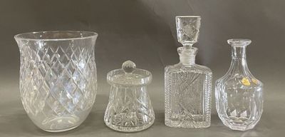 three glass vases and a glass bottle on a table