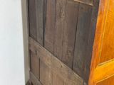 an old wooden dresser with a stone top in a room