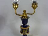 an image of a blue and gold table lamp with two glass globes on it