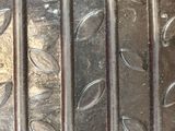 a close up of a metal plate with a pattern on it