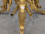 gold plated table with four figurines on top of it
