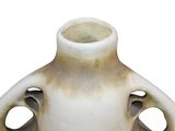a white vase with holes in it on a white background