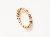 a close up of a gold ring with pink and white stones