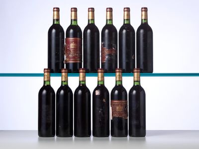 several bottles of wine sit on a glass shelf in front of a white wall