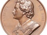 an image of a close up of a bronze coin with a woman ' s face