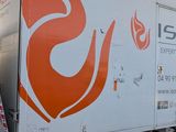 a white truck with an orange flame painted on the side of it