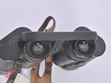 a pair of binoculars sitting on top of a wooden stand