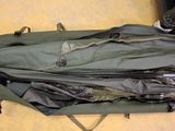a green bag with some items inside of it on the floor