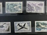 many different stamps on display in a glass case
