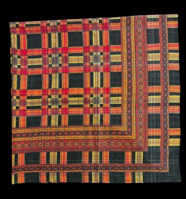 a close up of a red, yellow and black checkered cloth