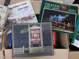 many books that are in a box on the floor