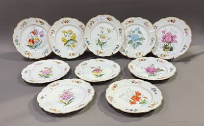 many plates with different designs on them on a table