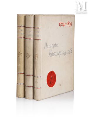 trois livres sont empilés sur une surface blanche