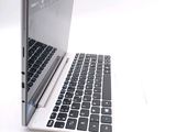a white laptop with a black keyboard on a white surface