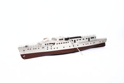 a small model of a boat on a white surface