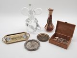 a small assortment of silver and glass items on a table